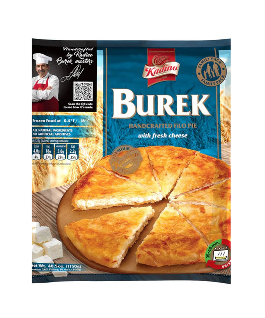 A blue and gold retail package of Kadino Burek, a handcrafted filo pie filled with fresh cheese. The front of the package features a large photograph of a round, golden-brown baked burek cut into triangular slices and served on a wooden board. Crumbled white cheese is pictured in the lower left corner, highlighting the filling. The package includes a family-pack badge, preparation information, and branding that emphasizes traditional handcrafted production